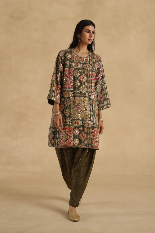 Beige kurta with red floral print, green embroidery and matching pants for women.